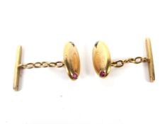 A pair of early 20th century gold, pink sapphire and diamond cuff links. Adapted from a single link.