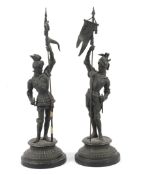 Two early 20th century bronzed spelter figures of armoured soldiers.