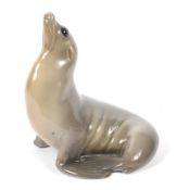 A Royal Copenhagen porcelain model of a seal. Printed blue and green marks, model no.