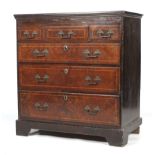 An 18th century walnut veneer and herring-bone inlaid oak lined chest of drawers.