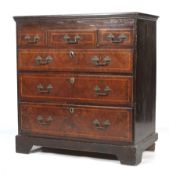 An 18th century walnut veneer and herring-bone inlaid oak lined chest of drawers.
