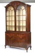 A mahogany Queen Anne style glazed cabinet on cupboard base.