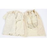 Two baby carrying capes. The first Victorian, in cream and partially lined in silk.