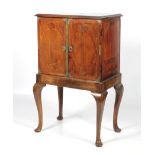 An 18th century walnut two door cabinet on stand.