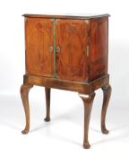 An 18th century walnut two door cabinet on stand.