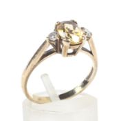 A citrine and zirconia dress ring. Hallmarked 375, size O.