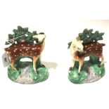 A pair of Staffordshire bocage models of deer. Standing over a stream and before foliage, H14.