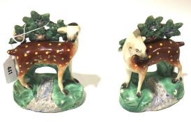 A pair of Staffordshire bocage models of deer. Standing over a stream and before foliage, H14.