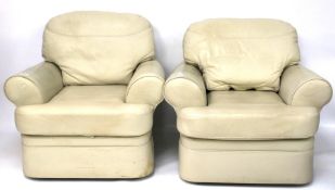 Two contemporary cream upholstered armchairs.