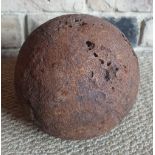 A large antique cast iron cannonball, 6".