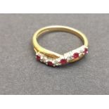 A modern 18ct gold ring set with 9 small rubies and diamonds, of twisted design - Birmingham