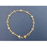 A modern sapphire & diamond set 18ct two colour gold bracelet, with 12 collet mounted stones, 7.5".