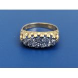 An 18ct gold ring set with two rows of small diamonds - London hallmarks. Finger size O/P.