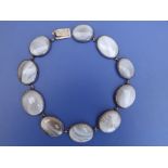 A Victorian silver choker necklace set with graduated oval panels of lace agate, 12".