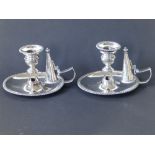 A pair of Regency crested silver chambersticks of plain design with gadrooned borders, detachable