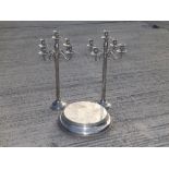 A large pair of 20thC EP candelabra, 29.5" high, together with a wedding cake stand, 19.5" diameter.