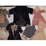 A large quanity of dolls' clothing including hats and dresses.