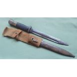 A WWII German bayonet, the pommel with Africa Korps emblem.