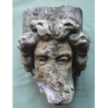 A heavy carved stone head, possibly Roman, 13.5" high.