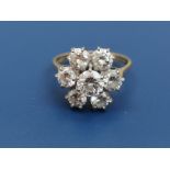 A seven stone diamond cluster ring, the largest brilliant to centre measuring 5.4mm diameter, on