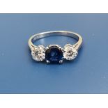 A three stone sapphire & diamond claw set ring in 18ct white gold & platinum. Finger size O.