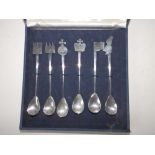 A cased set of six modernist silver spoons by Philippa Jane Merriman with differing heraldic devices
