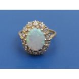An opal & diamond set 18ct gold oval cluster ring - Birmingham hallmarks. Finger size L.