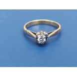 A small modern diamond solitaire ring, the stone of approximately 3mm diameter, on yellow metal