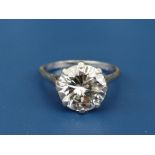 A diamond solitaire ring, the claw set brilliant weighing approximately 4 carats, on white metal