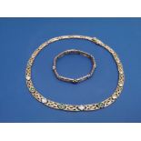 A 9ct gold necklace and matching bracelet in Celtic style, decorated with small quatrefoil