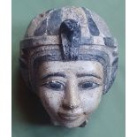 An Egyptian stone (?) head, depicting a female wearing headdress, with painted decoration, 5.9".