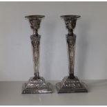 A pair of modern silver candlesticks, of square neoclassical form with detachable beaded sconces,