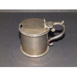 A Victorian plain silver mustard pot with rubbed engraved crest, beaded borders - RMEH, London 1888,