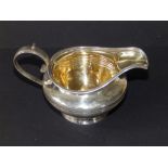 A William IV presentation silver cream jug with gilt interior, loop handle and reeded shoulders - '