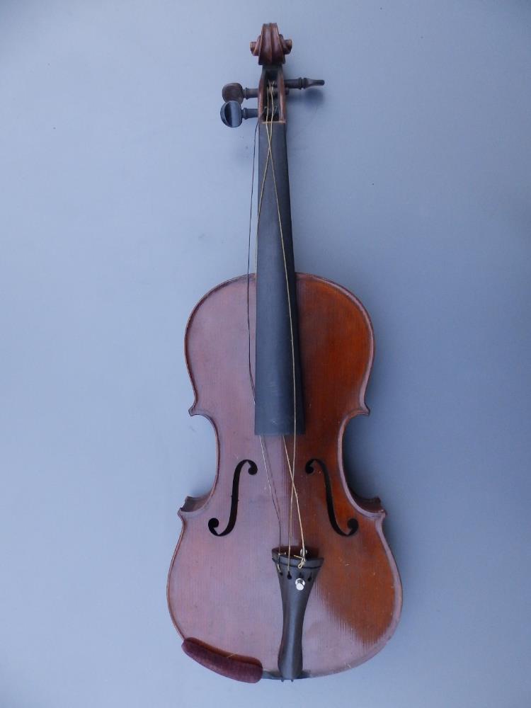 A Stradivarius copy violin by E R Schmidt & Co with 14.25" two piece back, together with two bows in