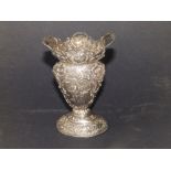 A late 19thC continental silver vase, repousse decoration cherubs, 4.25" high - repairs to rim.