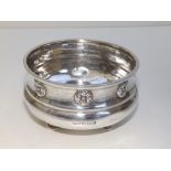 An Arts & Crafts beaten silver bowl by A. E. Jones, the sides having raised rosettes, standing on