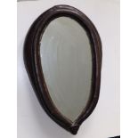 An oval leather horse collar framed mirror, 19" high overall.