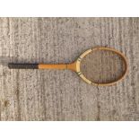 A mid 20thC tennis racquet - 'English Handmade Standard'.