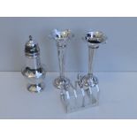 A Birmingham silver sugar caster, a Sheffield toast rack and a pair of spill vases - vases a/f. (4)