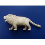 A late 19thC ivory lion, 6" across.