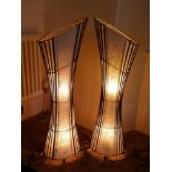 A pair of rosewood framed fabric electric lamps, comprising thin vertical slats of wood with