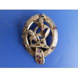 An Austro-Hungarian gilt metal openwork oval brooch depicting St George in combat, 2.3" high.