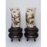 A pair of Japanese Meiji period shibayama inlaid ivory tusk vases, decorated in finely detailed gold