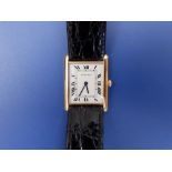 A boxed lady's 18ct gold Cartier Tank Quartz wrist watch, having sapphire endstone to crown, on