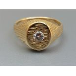 A modern diamond set signet ring in textured '18ct' gold, the stone weighing approximately 0.25