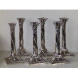 A matched set of six Edwardian silver candlesticks in the neoclassical style with London marks for
