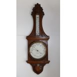 A carved oak banjo barometer/thermometer - W. Bruford & Son, Eastbourne, 35".