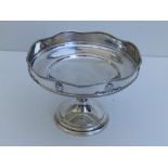 A silver comport, the reeded waved rim with raised anthemion decoration to sides - CCP, London 1913.
