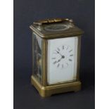 A brass gong-striking carriage clock, 5" high excluding handle - a/f.